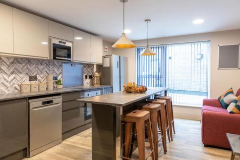 Modern kitchen island with bar stools and natur...