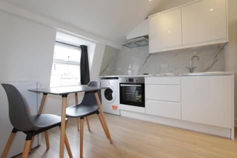 Sleek modern kitchen with bright dining space...
