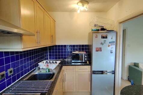 Bright kitchen with vibrant blue tile accents...
