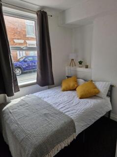 Bright bedroom with stylish ochre cushions...