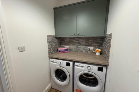 Neat utility area with side-by-side washer and ...