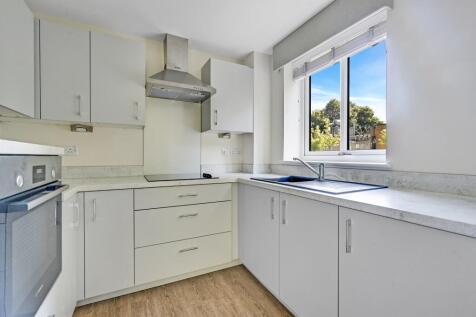 a kitchen with white cabinets