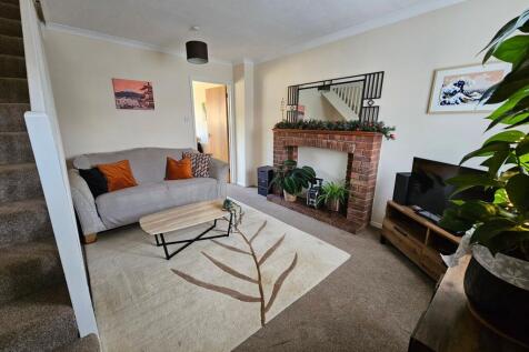 Bright, cozy living room with a comfy sofa, dec...