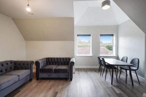 Bright lounge with plush sofas and dining area...