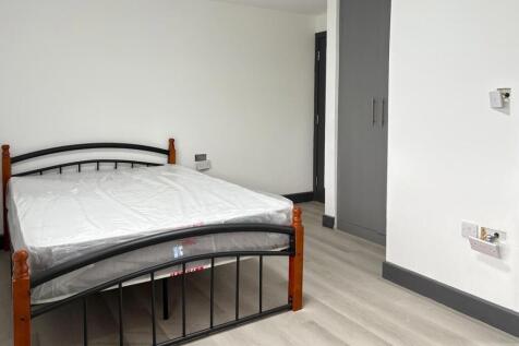 Neat, simply furnished bedroom with a double me...