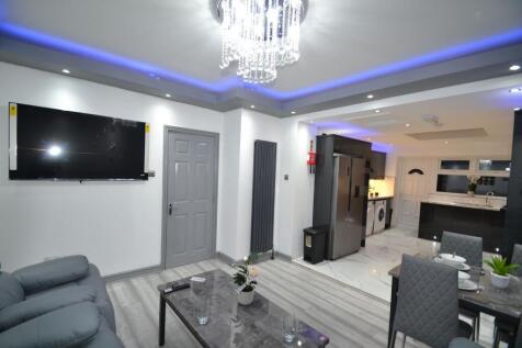 Stylish open-plan living area with modern grey ...