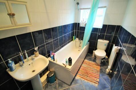 A well-maintained bathroom featuring a bathtub ...