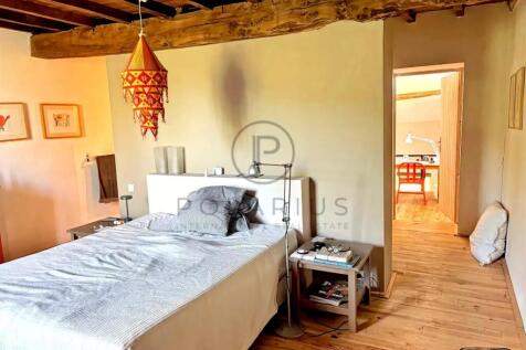 A cozy bedroom features a wooden ceiling, a double