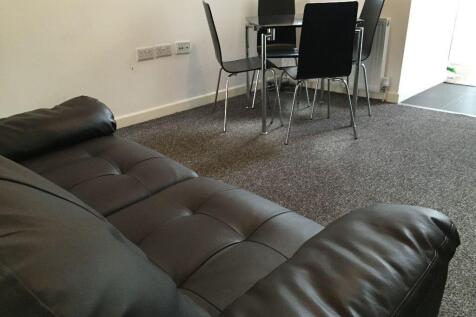 Bright living area with sleek dining set and so...