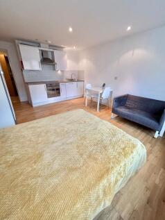 Bright studio space with modern kitchen and sof...