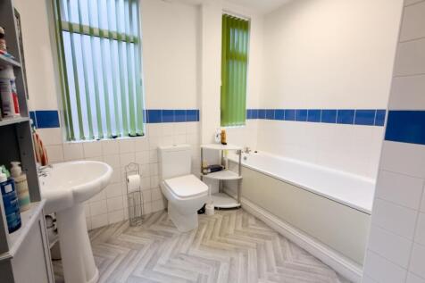Bright bathroom with bath and modern tiles...