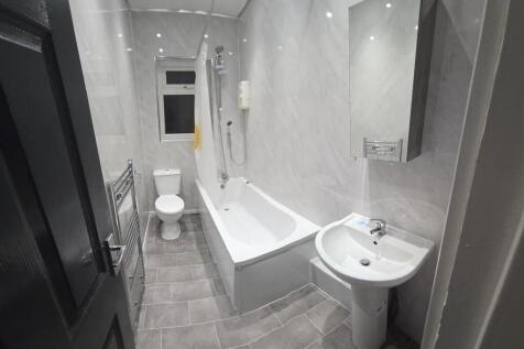 Modern bathroom suite with sleek marble-effect...