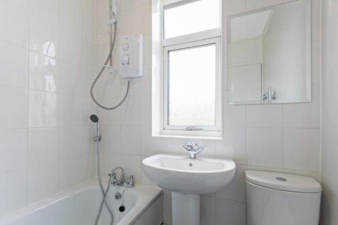 A bright and clean bathroom featuring a bath an...