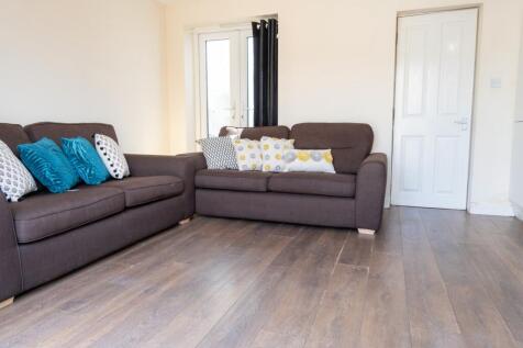 Bright and inviting living room featuring comfo...