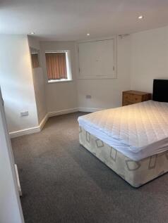 Spacious modern bedroom with plush grey carpet ...