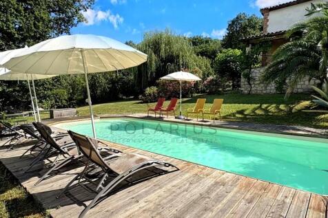 A serene swimming pool surrounded by lounge chairs