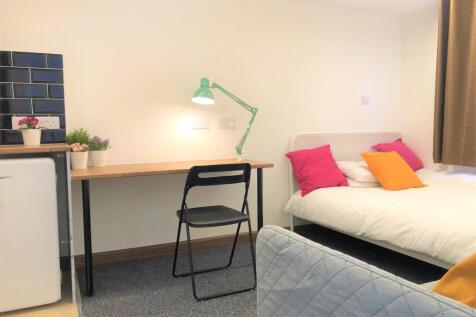Bright and tidy single bedroom featuring a cozy...