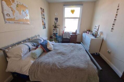 A spacious master bedroom featuring a double be...