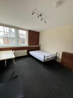 Bright, well-lit bedroom with a large sash wind...