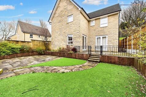 Spacious, Low-Maintenance Garden with Seating Areas and Garage Access