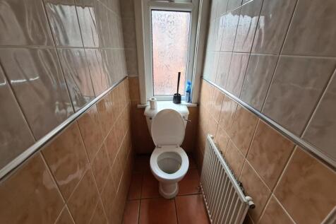 Compact, well-kept WC with tiled walls and floo...