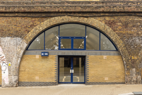 The front of an arch, with glazing on the bottom half and door allowing you to see into the arch interior.