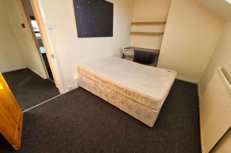 A spacious, well-maintained bedroom featuring a...