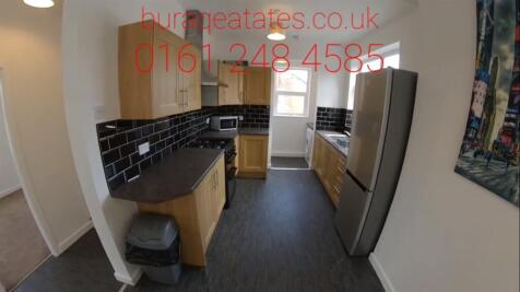 Bright galley-style kitchen with modern fitted ...