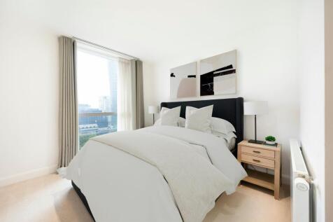 Experience comfort and style with this chic bedroom offering stunning city views.