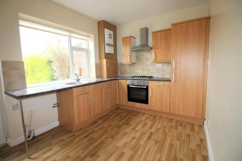 Bright kitchen with modern wood-finish cabinetr...