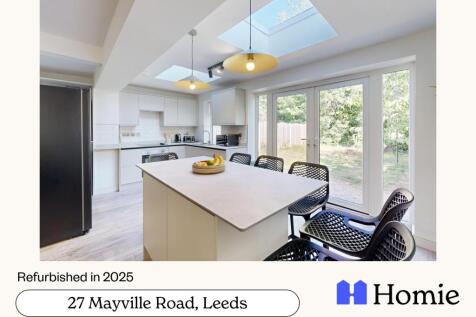 Bright, modern open-plan kitchen with a central...