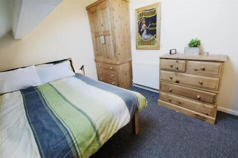 Bright bedroom with ample pine storage and doub...