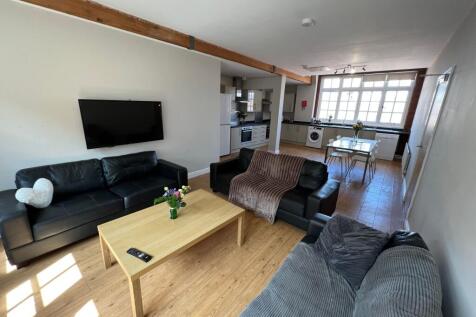 Bright and spacious living room featuring comfo...