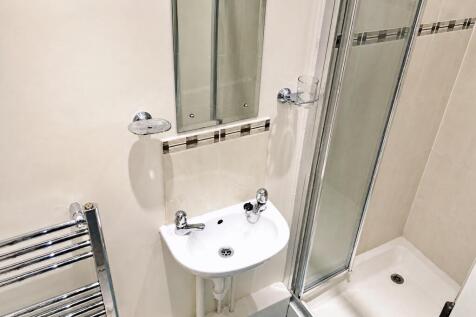 Clean modern bathroom with walk-in shower...