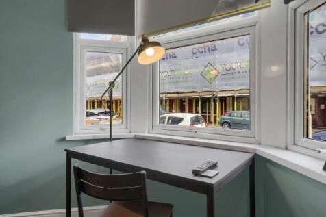 Bright study area with large windows and desk...