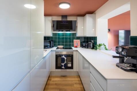 Stylish modern kitchen with vibrant green tiles...