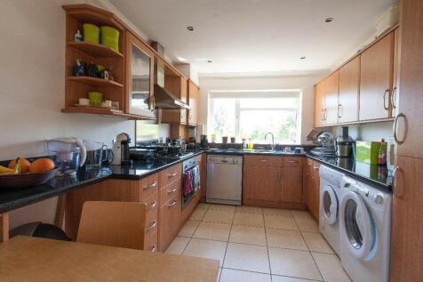 Spacious kitchen with modern appliances and lig...
