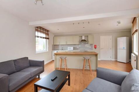 Bright open-plan living area with modern kitche...