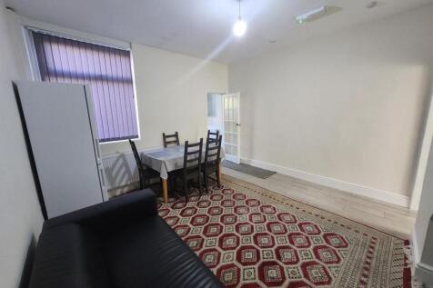 Bright furnished living room with seating, dini...