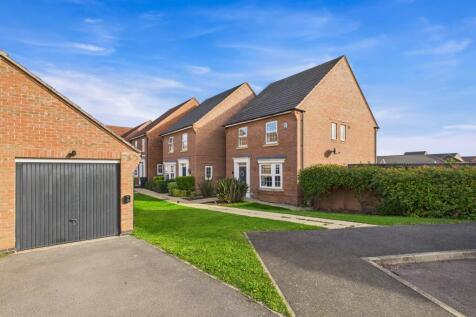 A boarded garage with storage and an EV charger co