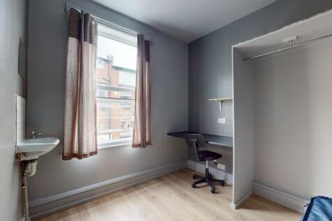 A simple, functional room featuring a large win...