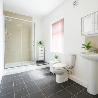 Bright and modern bathroom with walk-in shower...