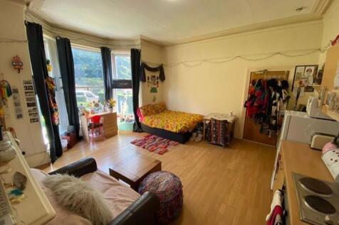 Spacious master bedroom featuring a cozy double...
