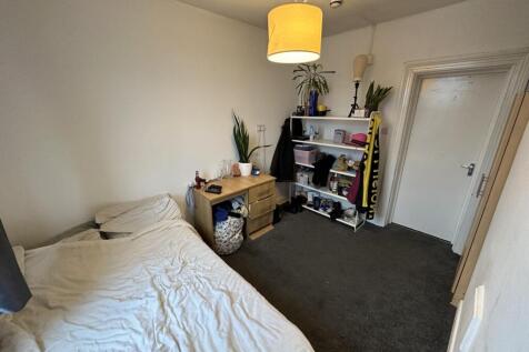 Comfortable bedroom with desk and ample storage...