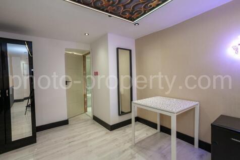 Bright, modern bedroom with light wood floors, ...