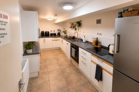 Modern kitchen with sleek white cabinetry...