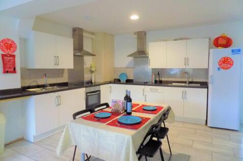 Bright and modern kitchen featuring white cabin...