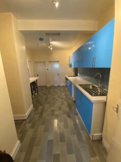 Modern kitchen with vibrant blue cabinetry...