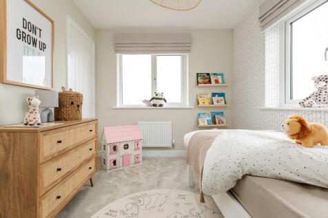 Two windows in the fourth bedroom fill the room with light