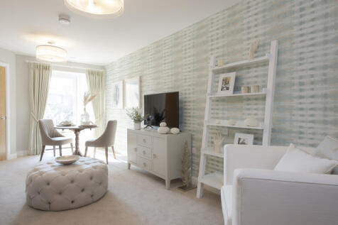 a living room with a white couch and a white table